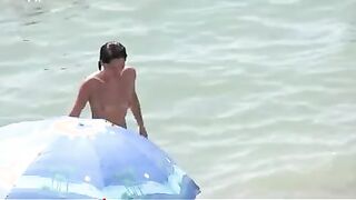 Watch these smooth nudists play at a public beach