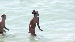 Watch these smooth nudists play at a public beach