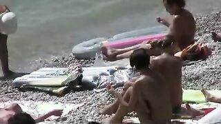 Nudist girls have fun with each other at the beach