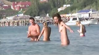 Nudist girls have fun with each other at the beach