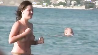 Nudist girls have fun with each other at the beach