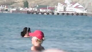 Nudist girls have fun with each other at the beach