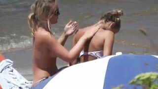 Beach Girls topless tanning