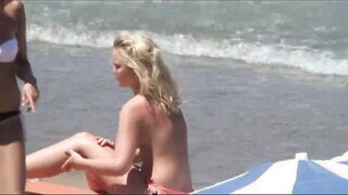 Beach Girls topless tanning