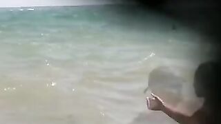 Watch a naked chick at the beach tan her hot body