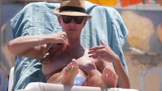 Frisky blonde babe expose her perky awesome tits on topless beach