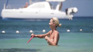 Frisky blonde babe expose her perky awesome tits on topless beach