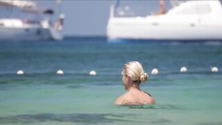 Frisky blonde babe expose her perky awesome tits on topless beach