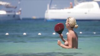 Frisky blonde babe expose her perky awesome tits on topless beach