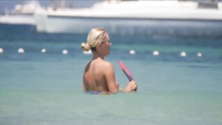 Frisky blonde babe expose her perky awesome tits on topless beach