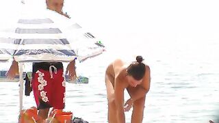 Nude beach wife exposing her hairy pussy