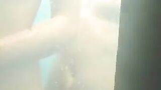 Nude girls caught by spy cam on beach shower cabin