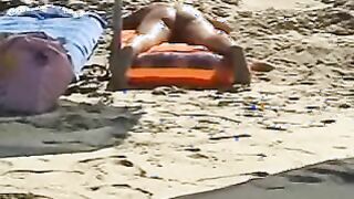 Beach spread on a nude beach of a Milf