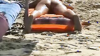 Beach spread on a nude beach of a Milf