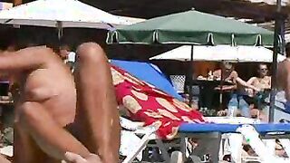 Nudist brunette curly babe exposed on the beach