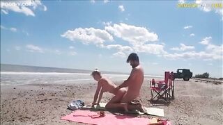 Wife with strangers on beach