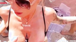 Public slut pleasures group of men on beach